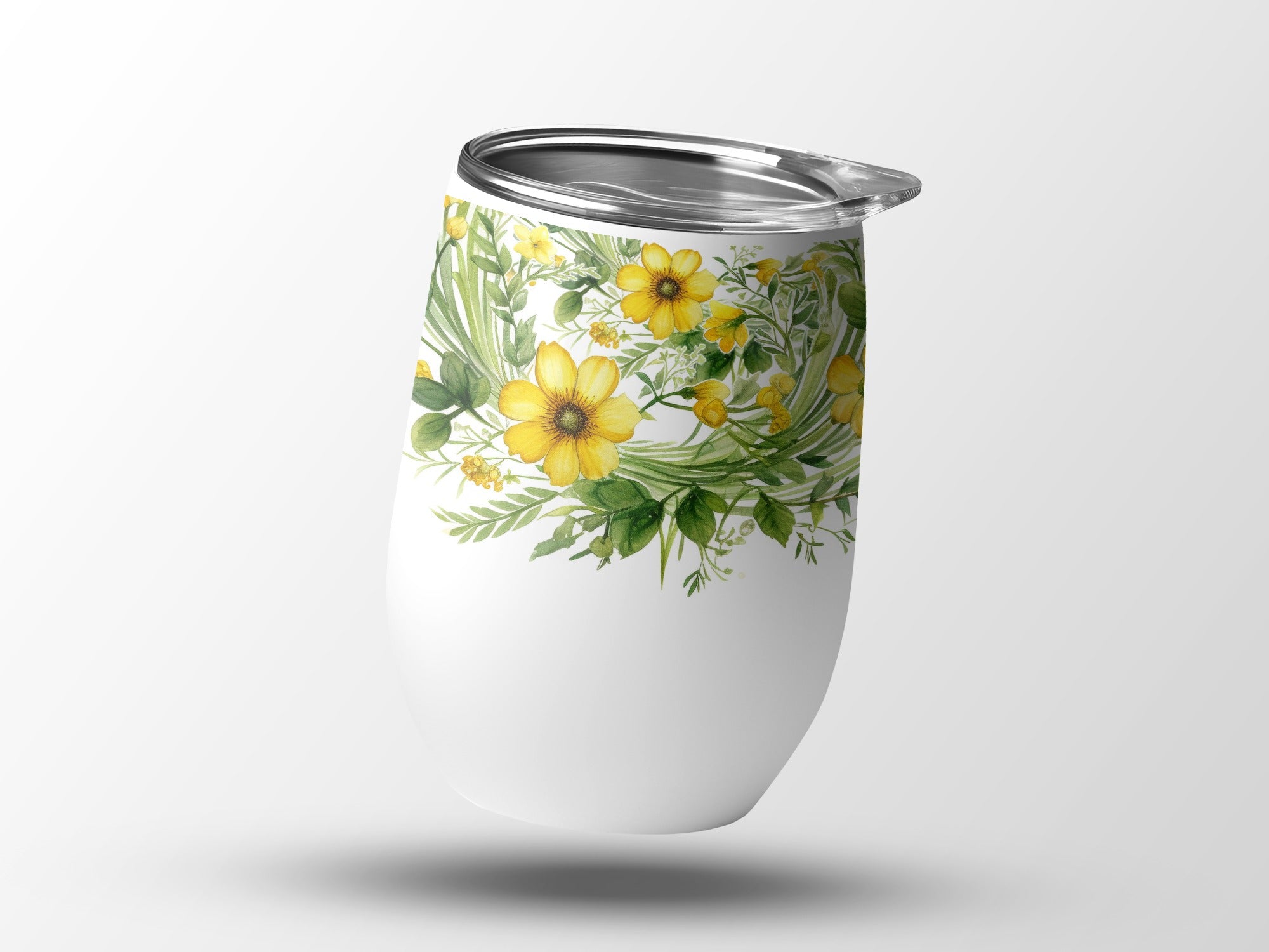 White tumbler with a vibrant yellow floral and green leaf design.