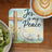 Jesus is my Peace coaster with a dove and crosses, next to kiwi and coffee.