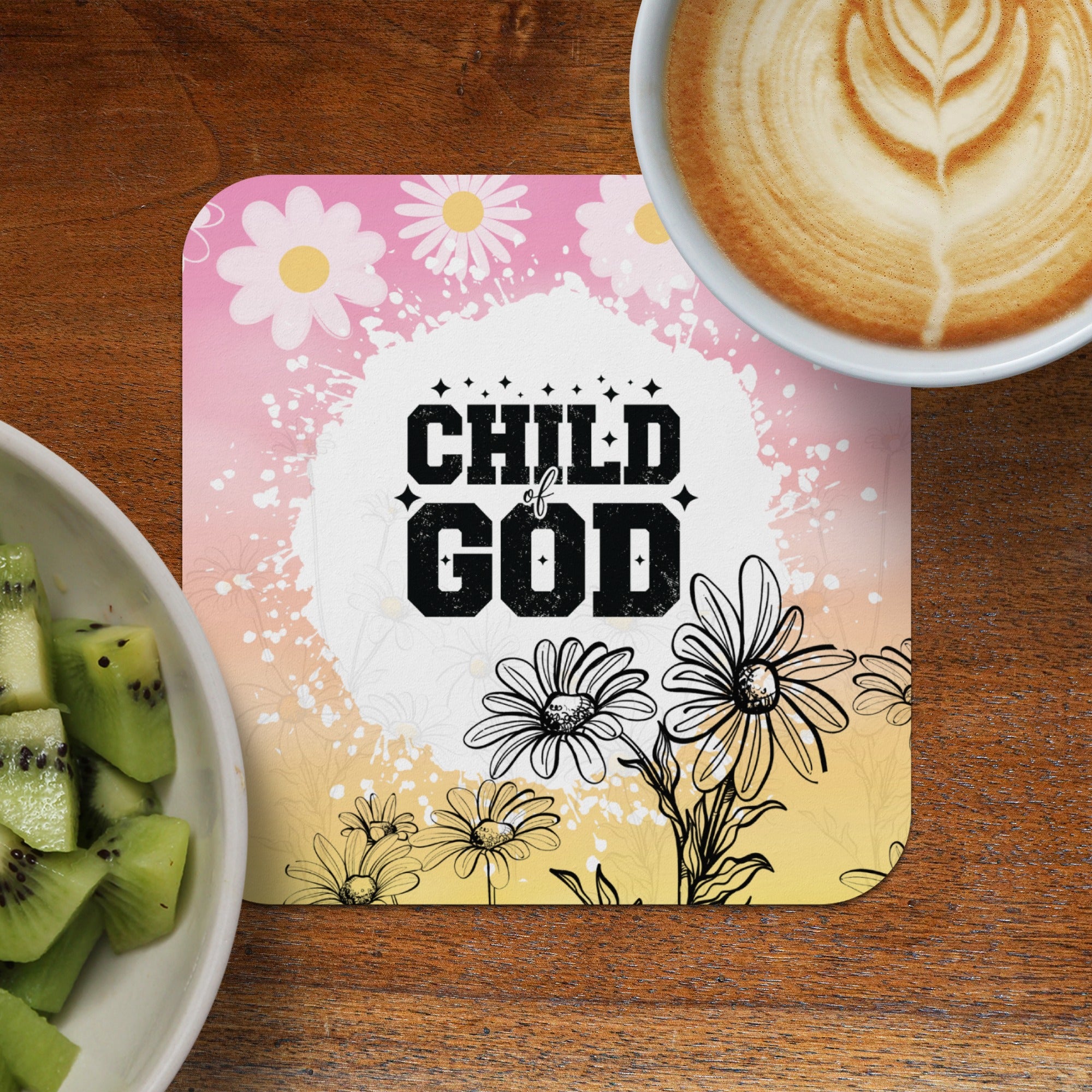 Child of God quote on square coaster with daisies, coffee, and kiwi.