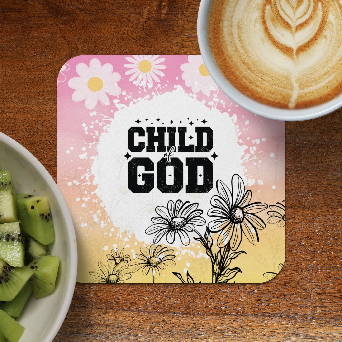Child of God quote on square coaster with daisies, coffee, and kiwi.