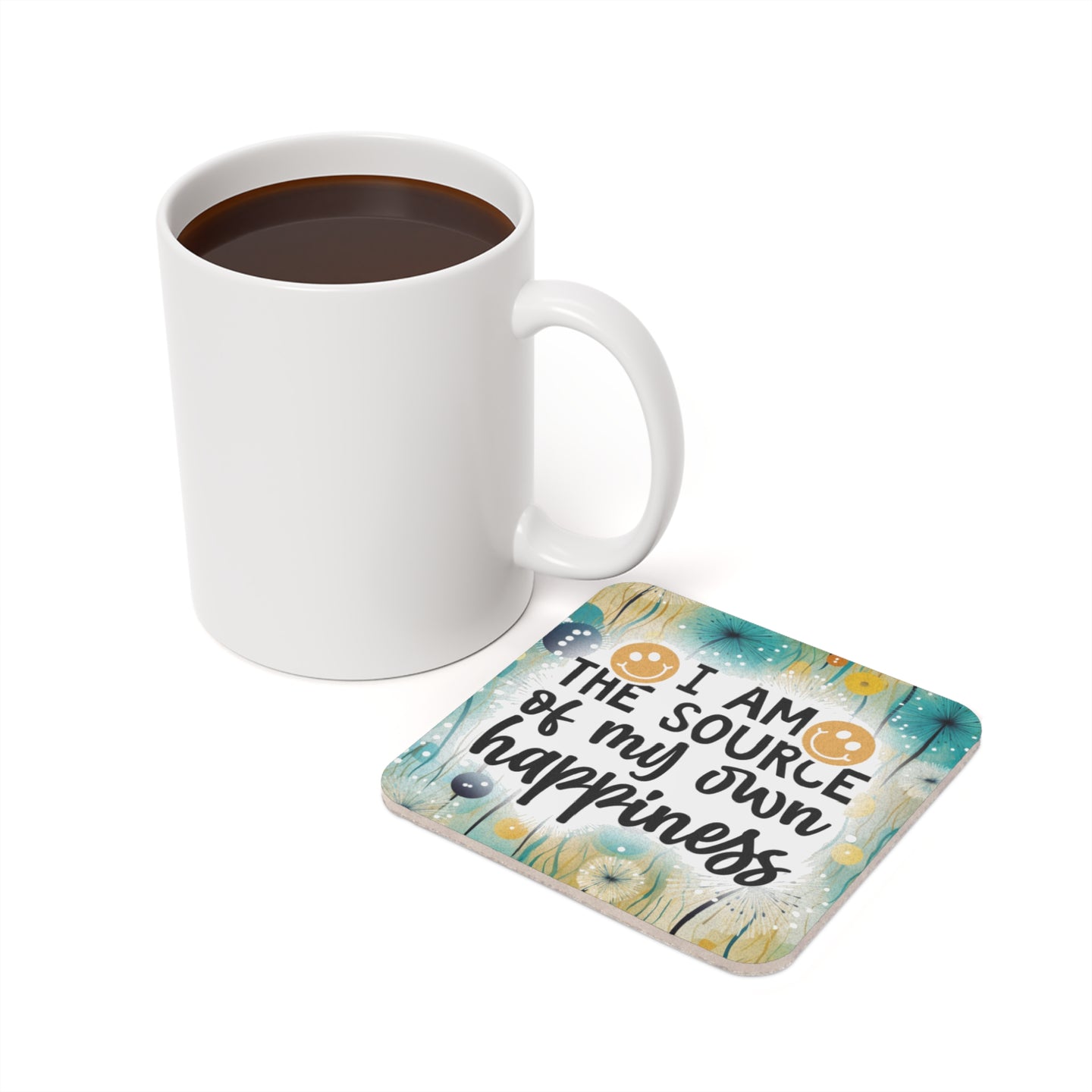 Mug of coffee next to coaster with "I AM THE SOURCE of my own happiness" text.