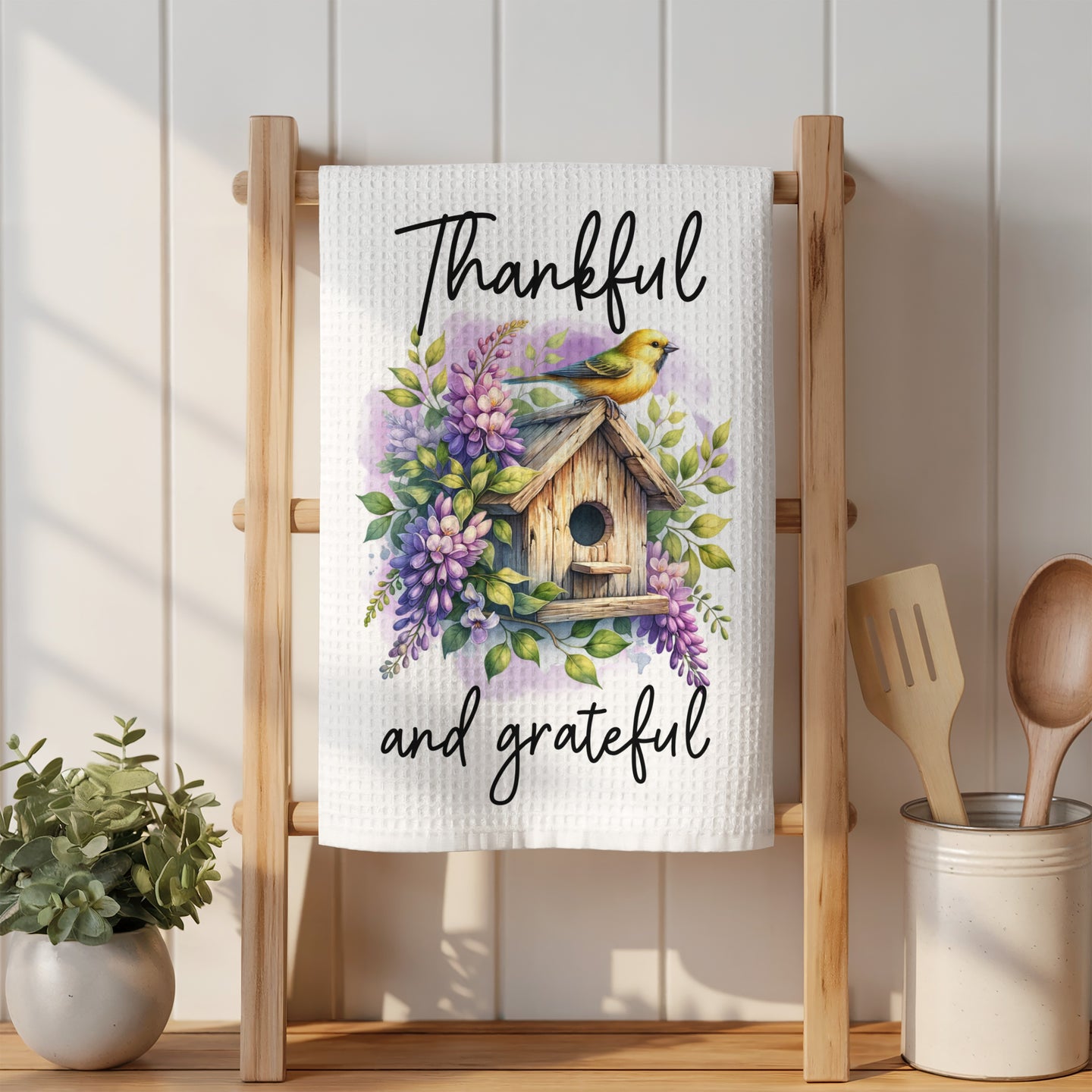 White kitchen towel with birdhouse, flowers, and "Thankful and grateful" text.