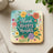 Coaster with "Think happy thoughts" text and colorful floral illustrations.