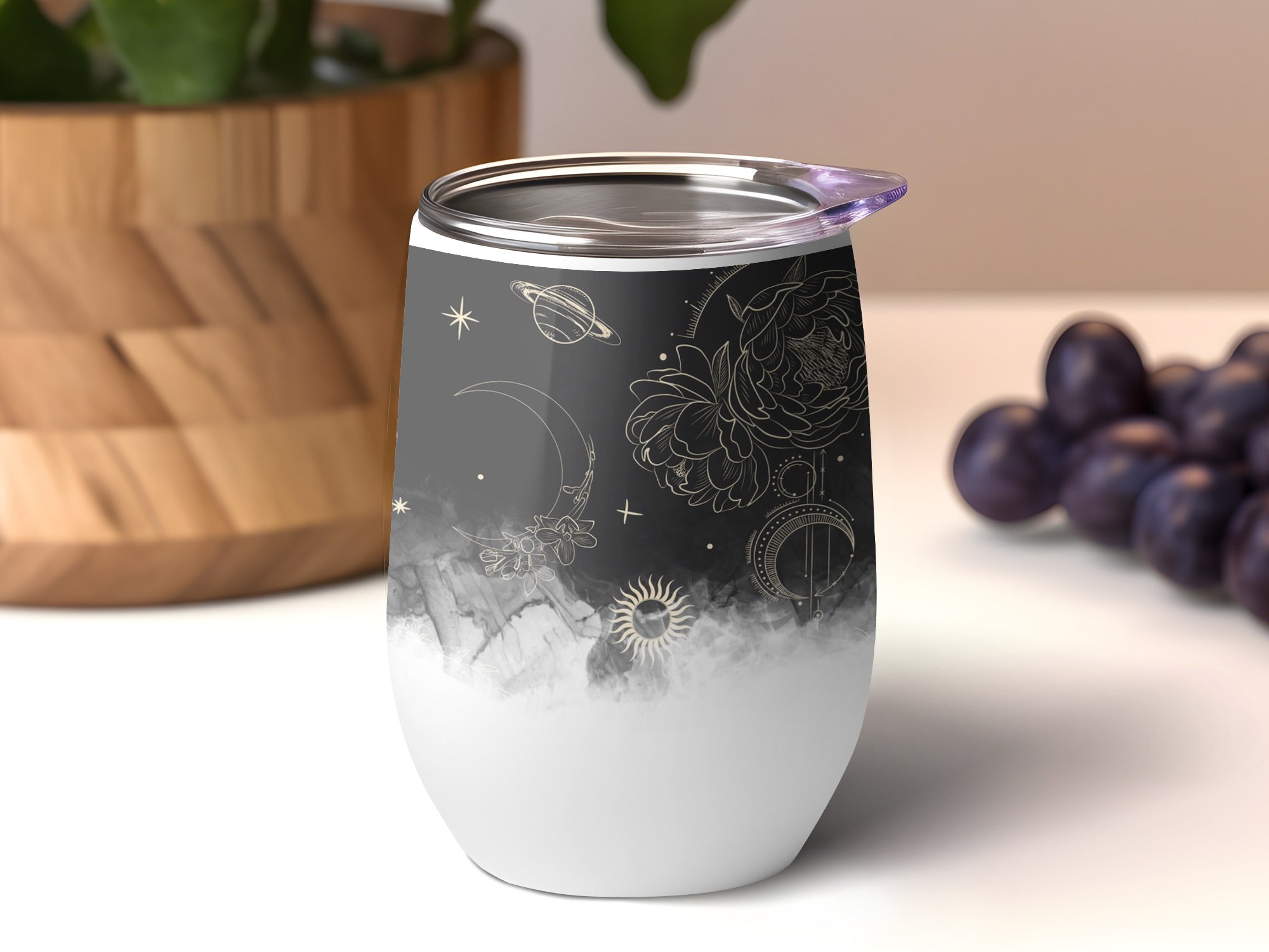 White tumbler with celestial moon and star design.