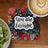 Coaster with "You are enough" text and floral design, next to kiwi slices and coffee.
