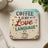 Wooden coaster with "Coffee is my Love Language" text and smiling coffee cup.