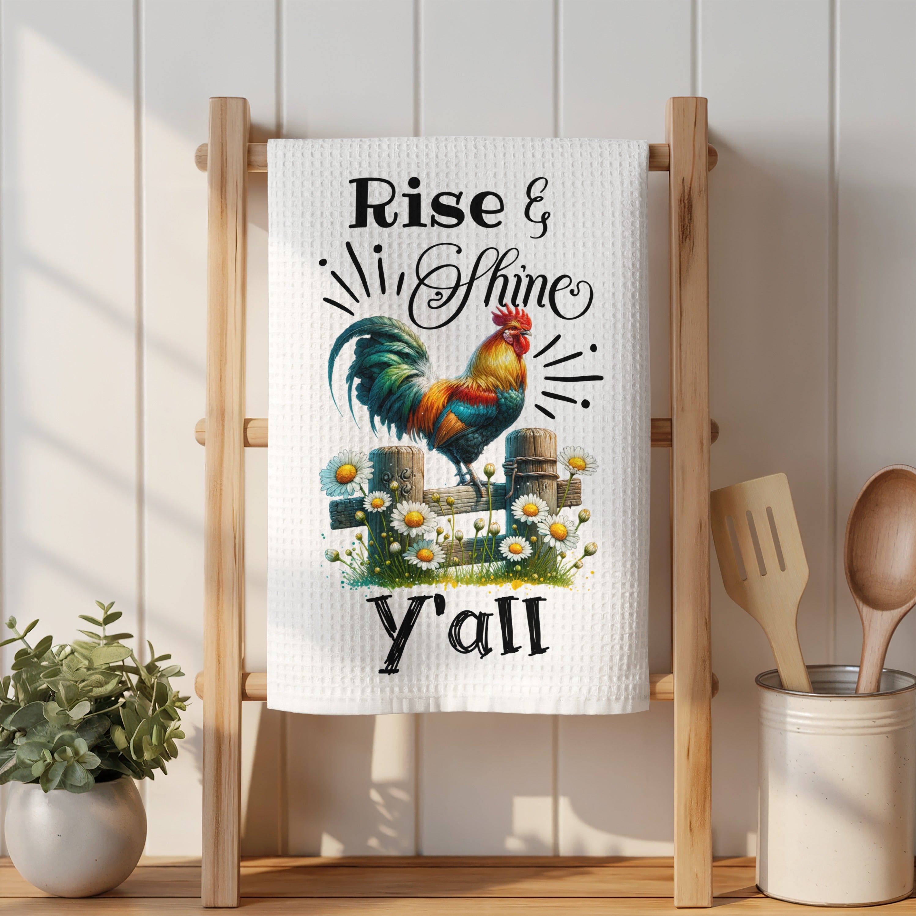 White kitchen towel with "Rise & Shine Y'all" and a rooster illustration.