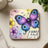 Butterfly design with "Lead" text on a square coaster.