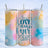 Tumbler with "True Love Has Paws" text on a watercolor background.