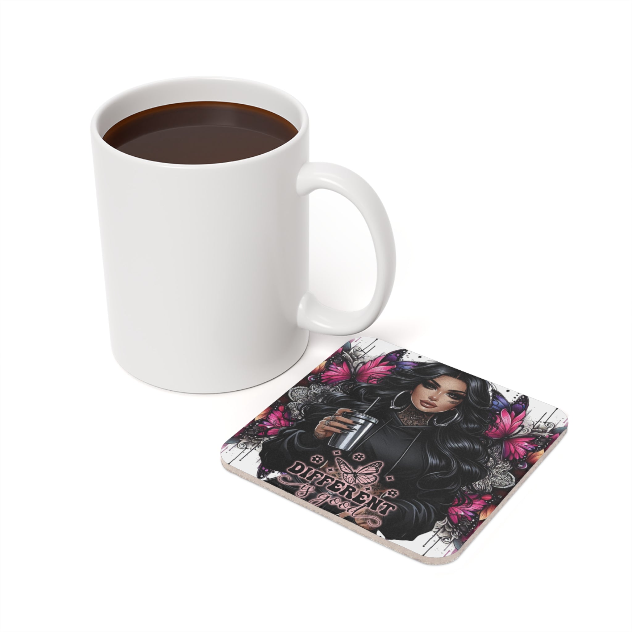 White coffee mug next to a coaster with a tattooed woman and butterflies.