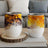 Two white tumblers with abstract orange and yellow marbled designs.
