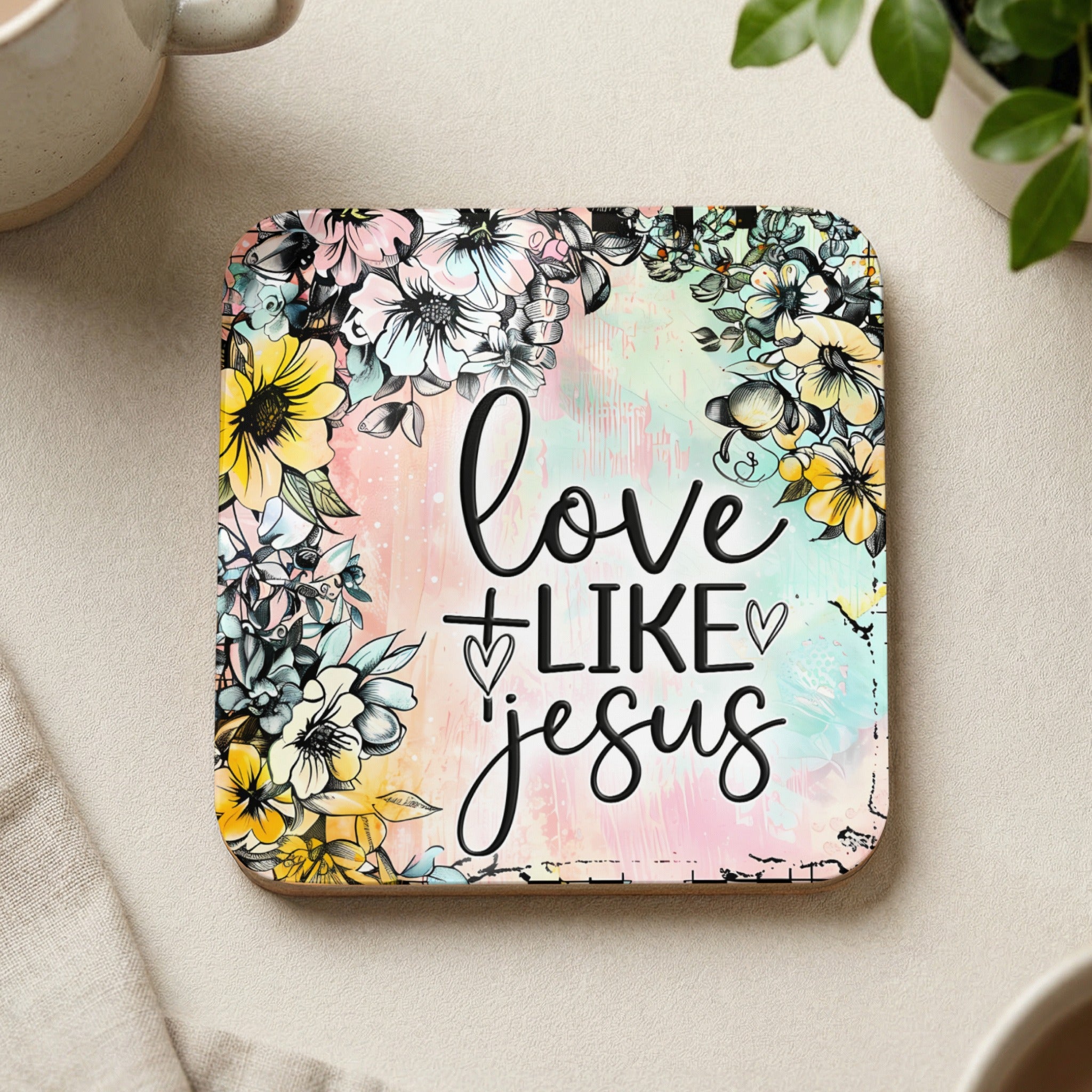 Coaster with "Love Like Jesus" text surrounded by floral watercolor design.