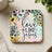 Coaster with "Love Like Jesus" text surrounded by floral watercolor design.
