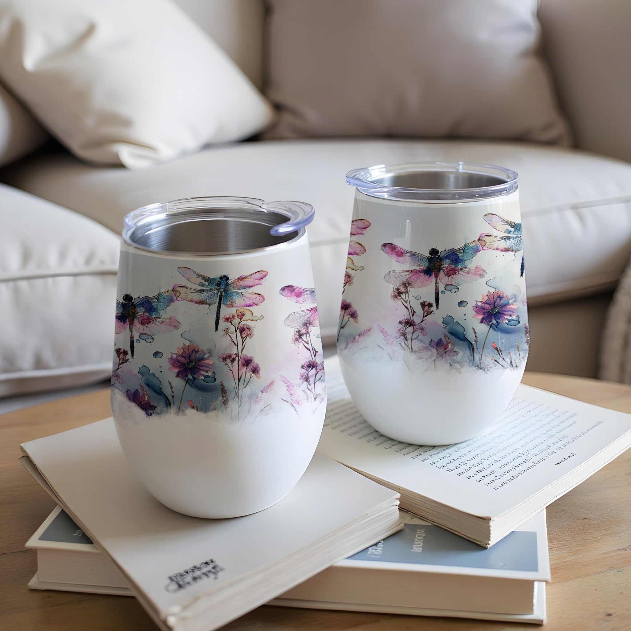 Two white tumblers with watercolor dragonflies and floral designs.