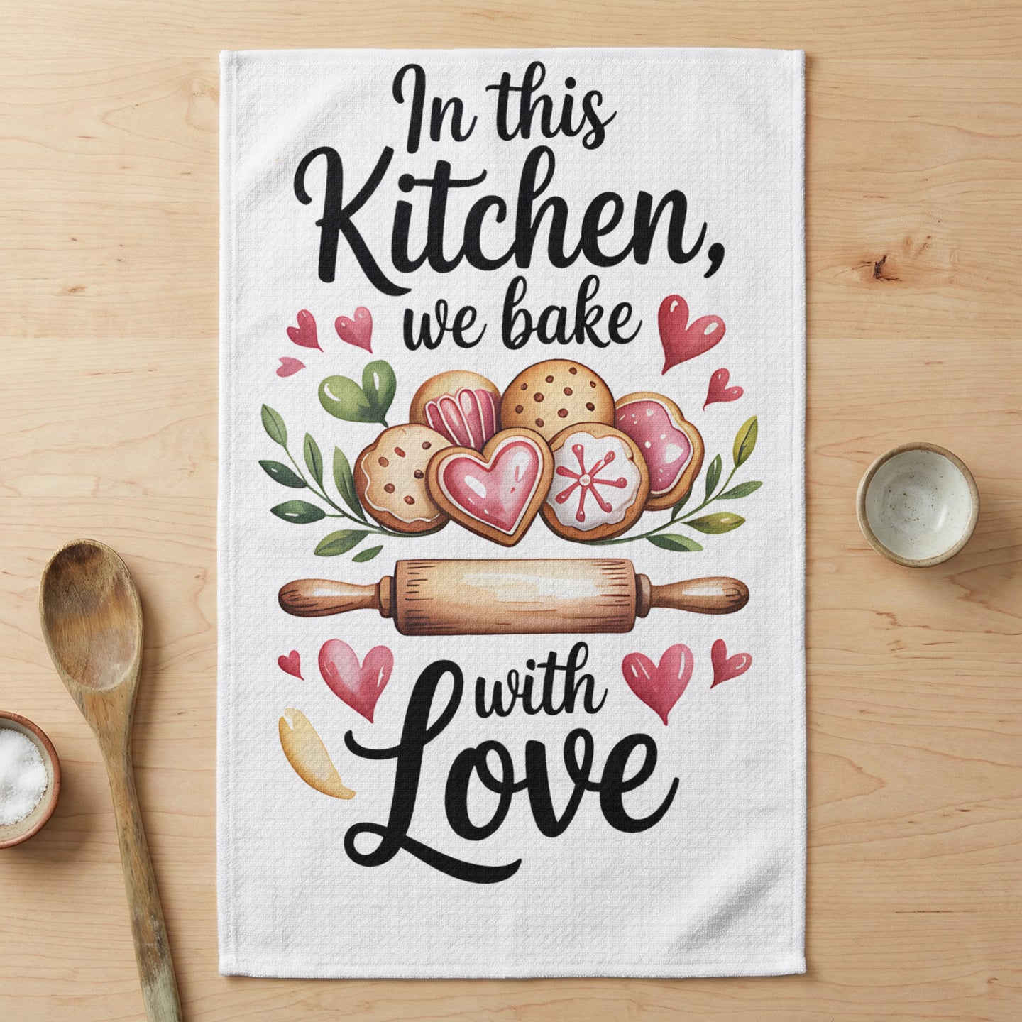 Kitchen towel with watercolor cookies and text "In this Kitchen, we bake with Love."