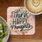 Coaster with "Think Happy Thoughts" text and floral design next to coffee and kiwi.