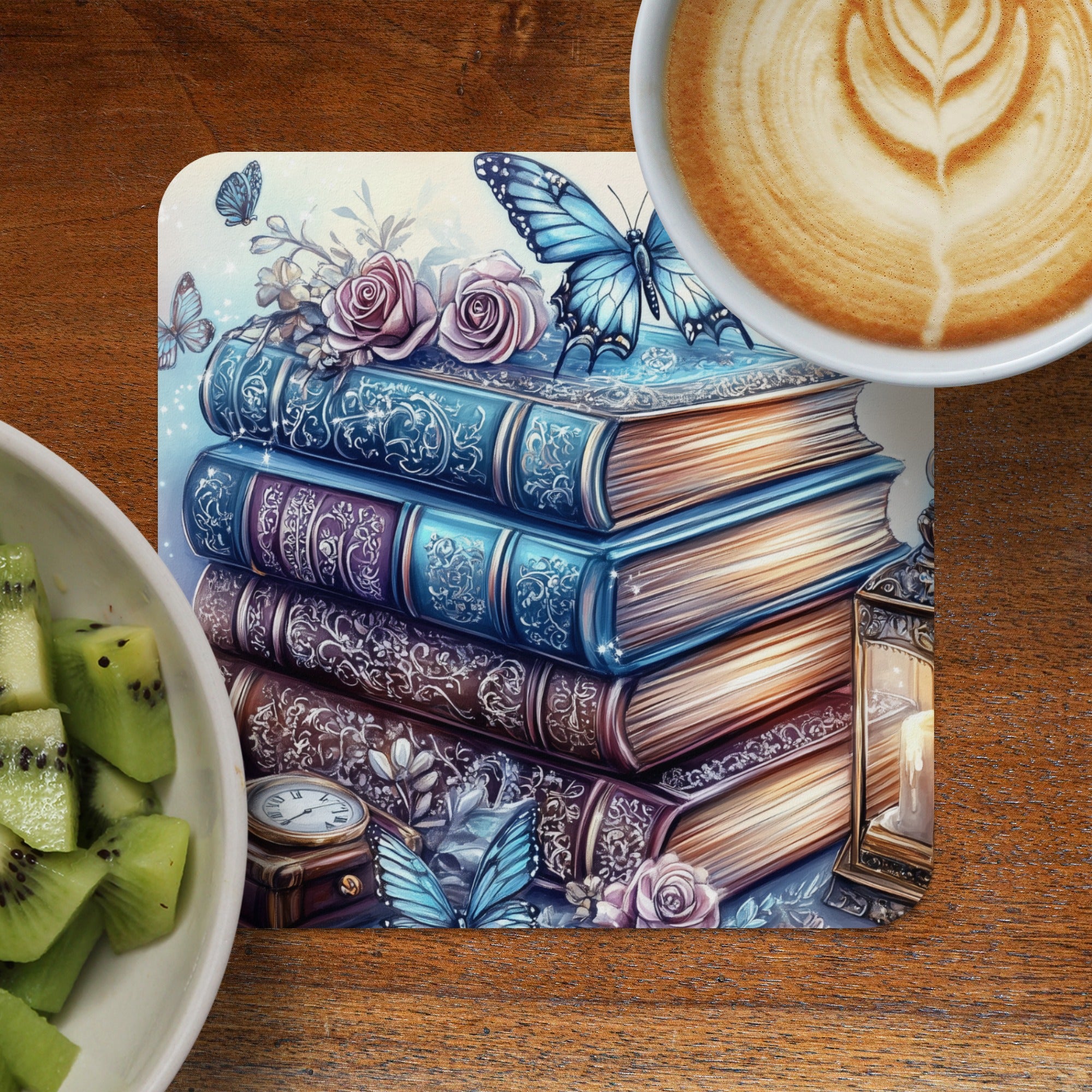 Stack of vintage books with butterflies and roses, next to coffee and kiwi.