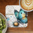 Turquoise butterfly on daisy, "UNSTOPPABLE" text, latte, and kiwi.