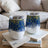 Two blue and gold speckled tumblers on a book.