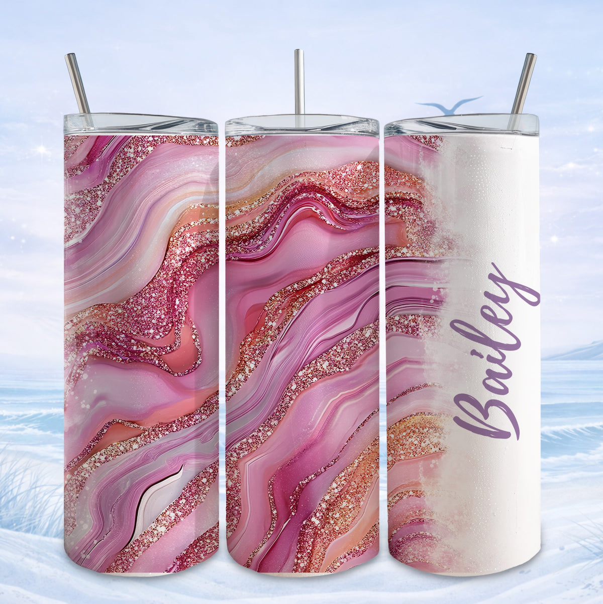 Pink and gold marble tumbler with "Bailey" text, shown in a scenic winter display.