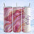 Pink and gold marble tumbler with "Bailey" text, shown in a scenic winter display.