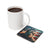 Gorilla in sunglasses with American flag on a coaster next to coffee mug.