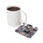 White mug and coaster with skull, sunflowers, and "Not Perfect, Just Real" text.