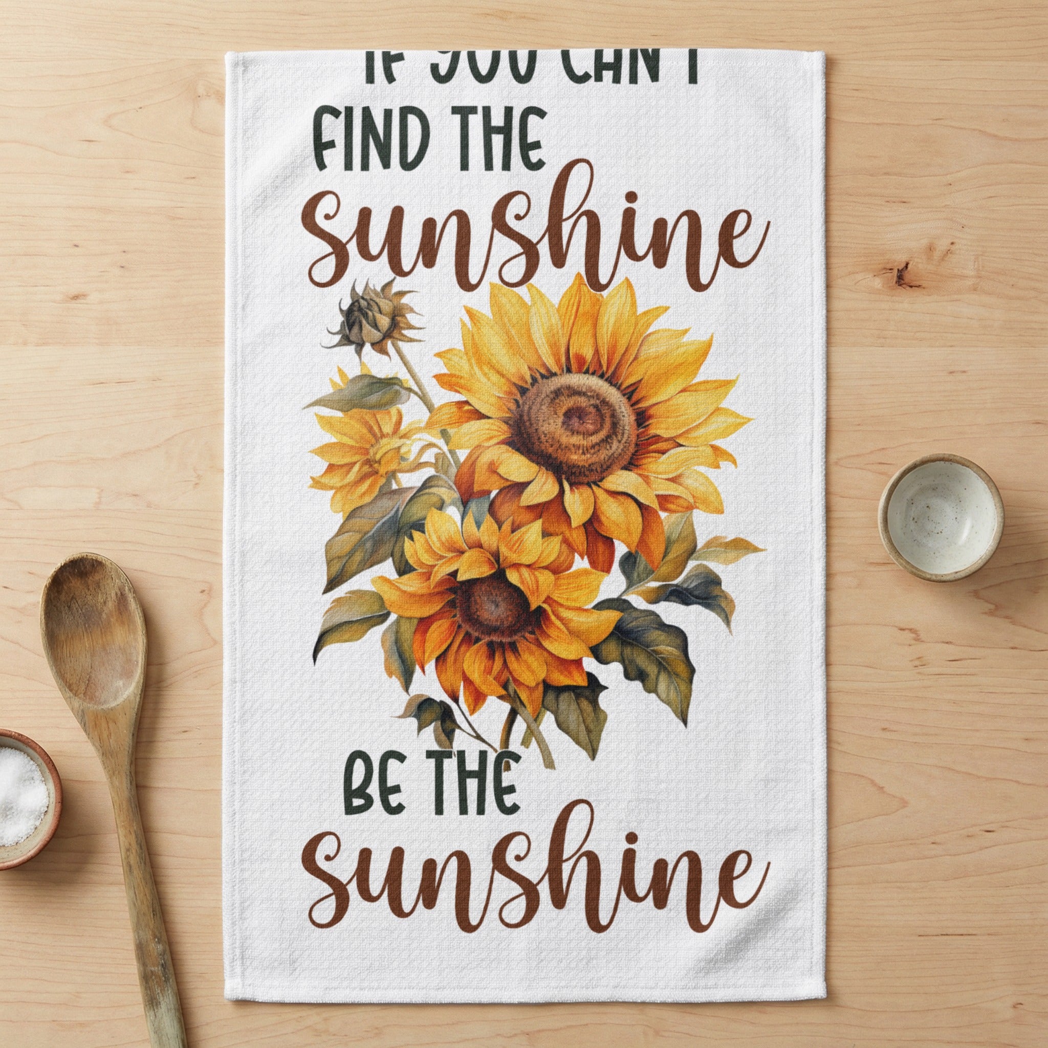 White tea towel with sunflowers and the text "FIND THE sunshine BE THE sunshine".