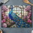 Stained glass cutting board with peacock and floral border.