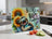 Sloth holding a book, surrounded by sunflowers and text: "BOOKS, NAPS & SUNFLOWERS".
