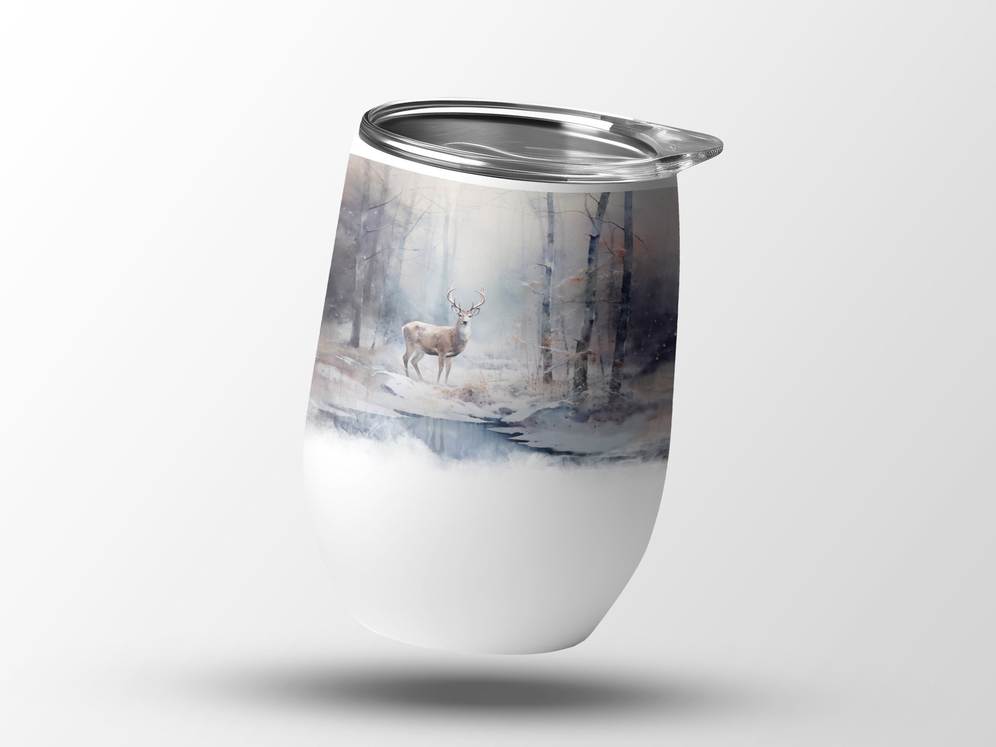 White tumbler with a deer in a snowy forest scene.