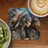 Woman in Native American headdress with horse and coffee.