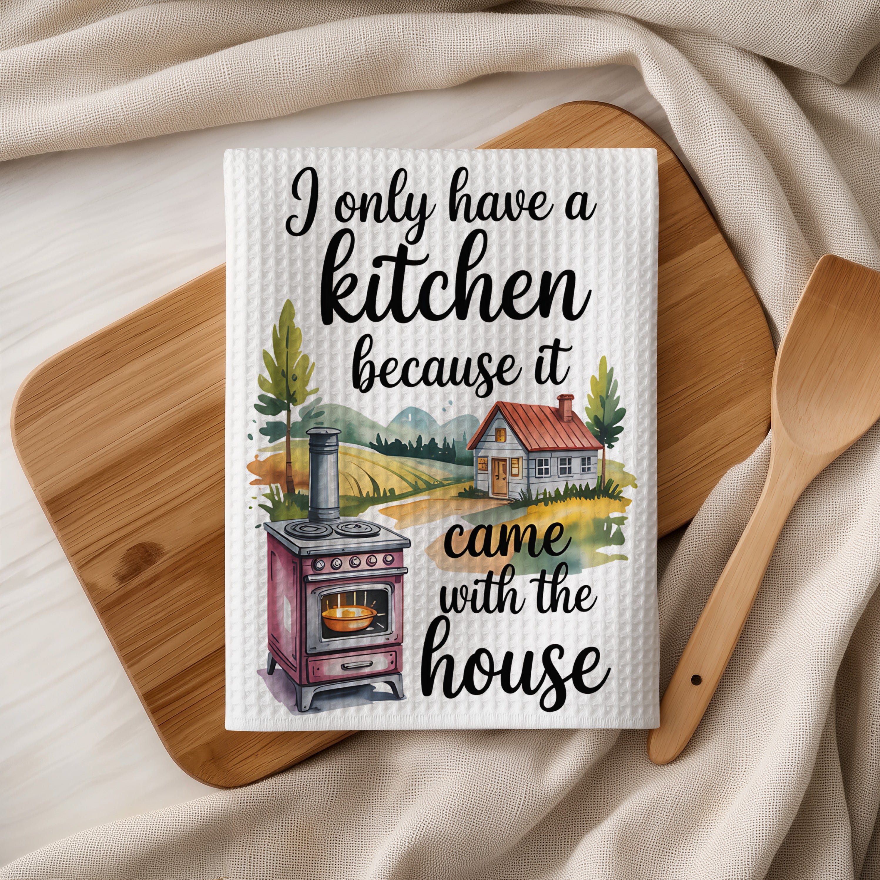 Kitchen towel with text "I only have a kitchen because I came with the house."