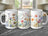 Three white mugs with watercolor floral designs on a dark marble surface.