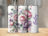 Three tumblers decorated with a watercolor floral pattern and the name "Bailey".