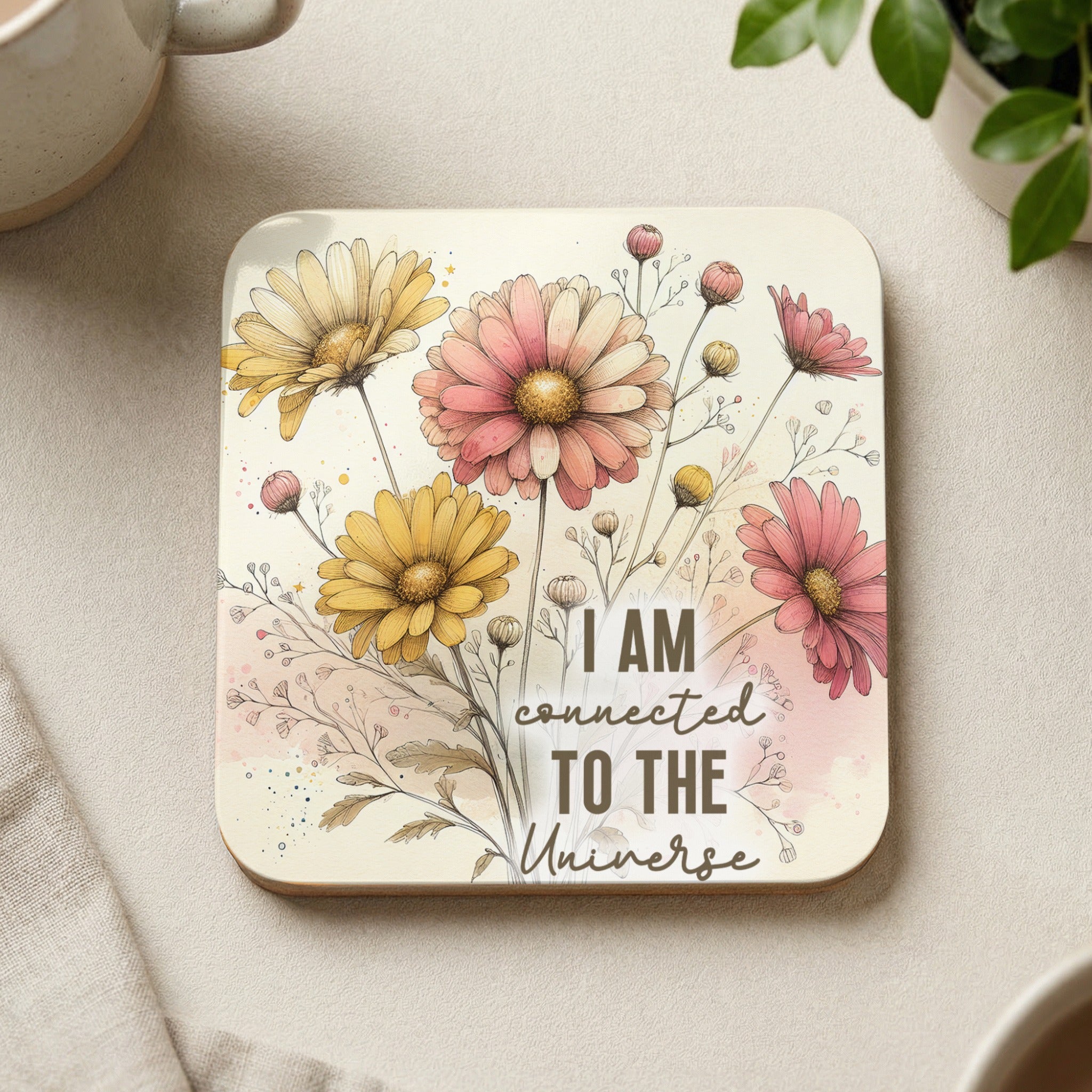 Square coaster with floral design and text "I AM CONNECTED TO THE UNIVERSE".