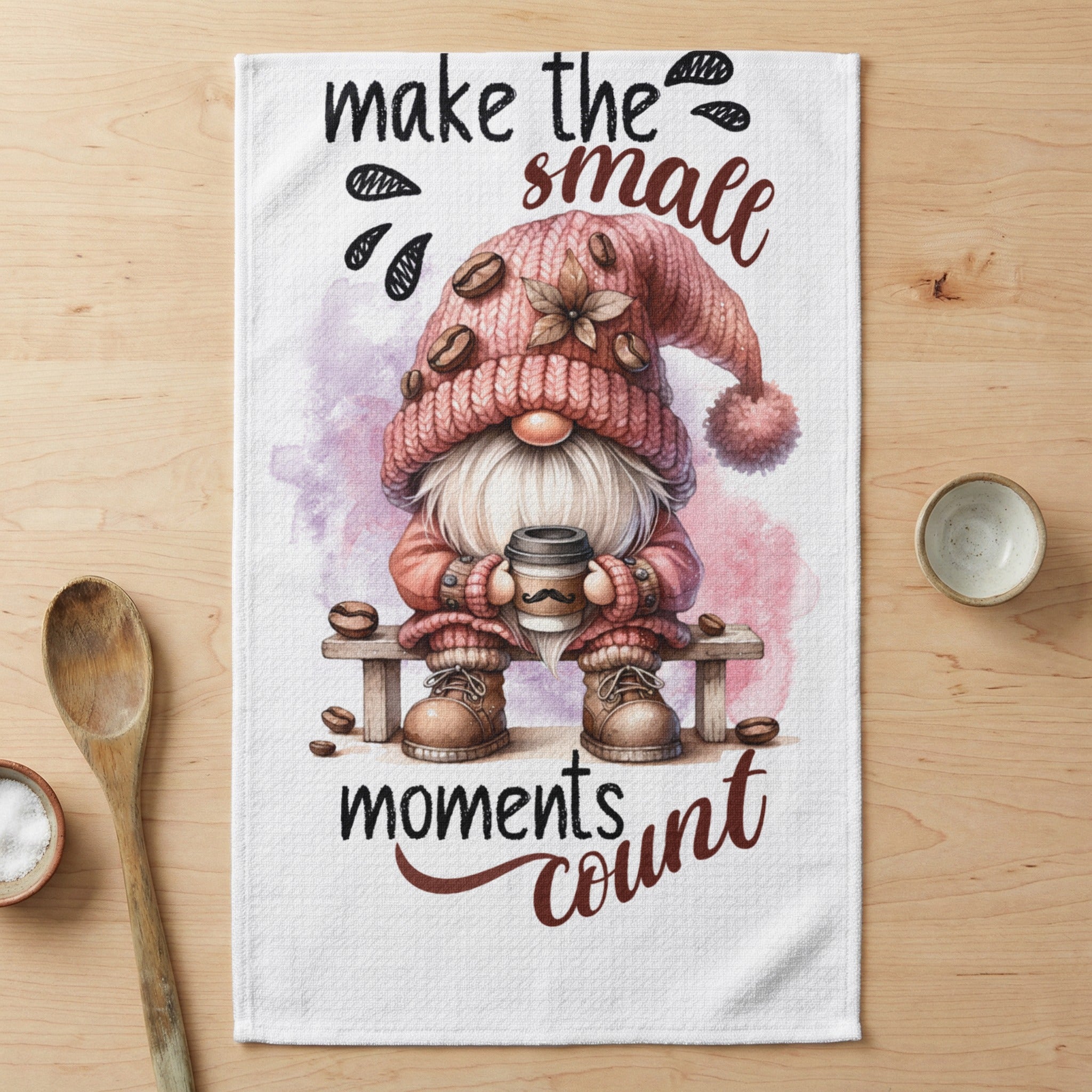 Gnome in pink hat holds coffee cup with text "make the small moments count."