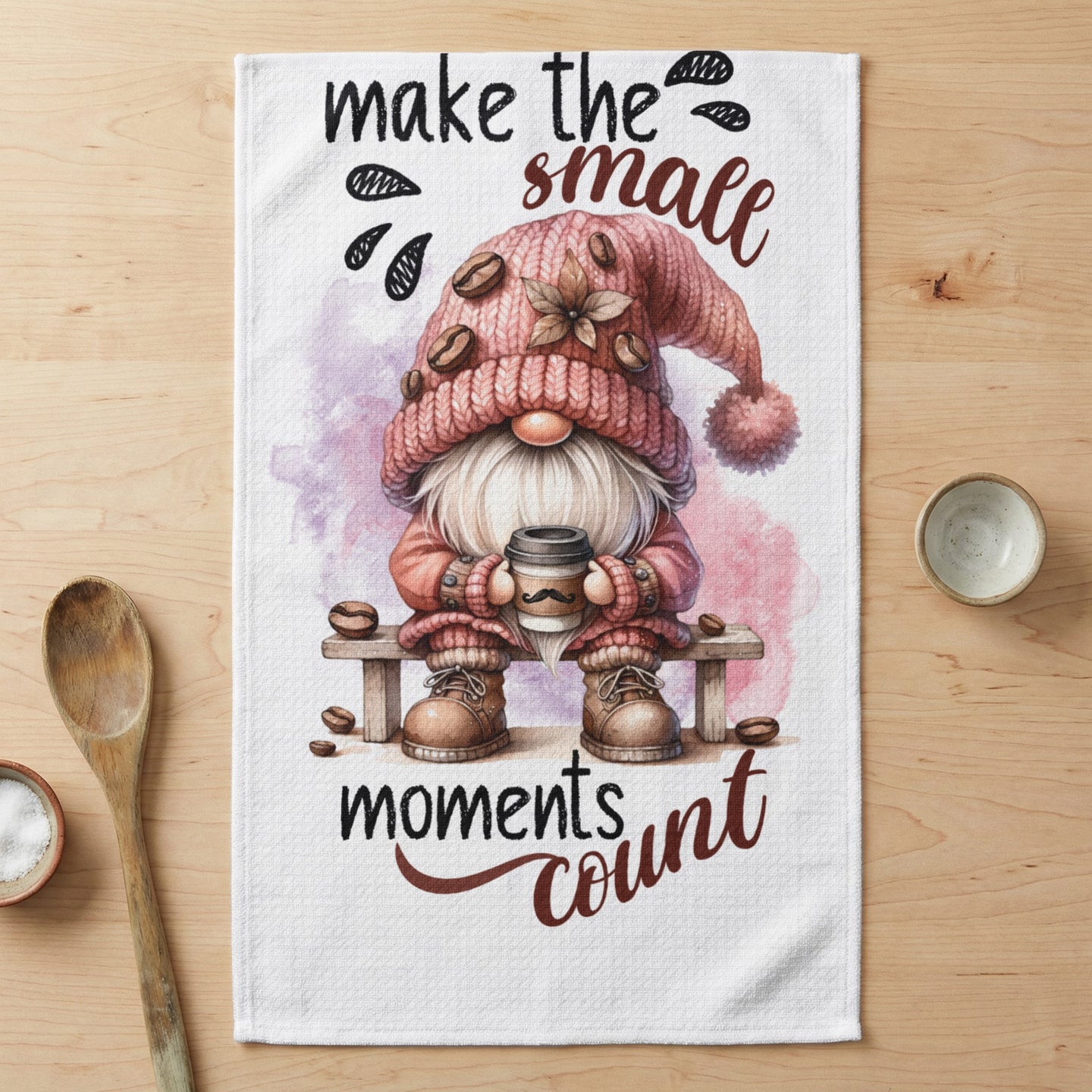 Gnome in pink hat holds coffee cup with text "make the small moments count."