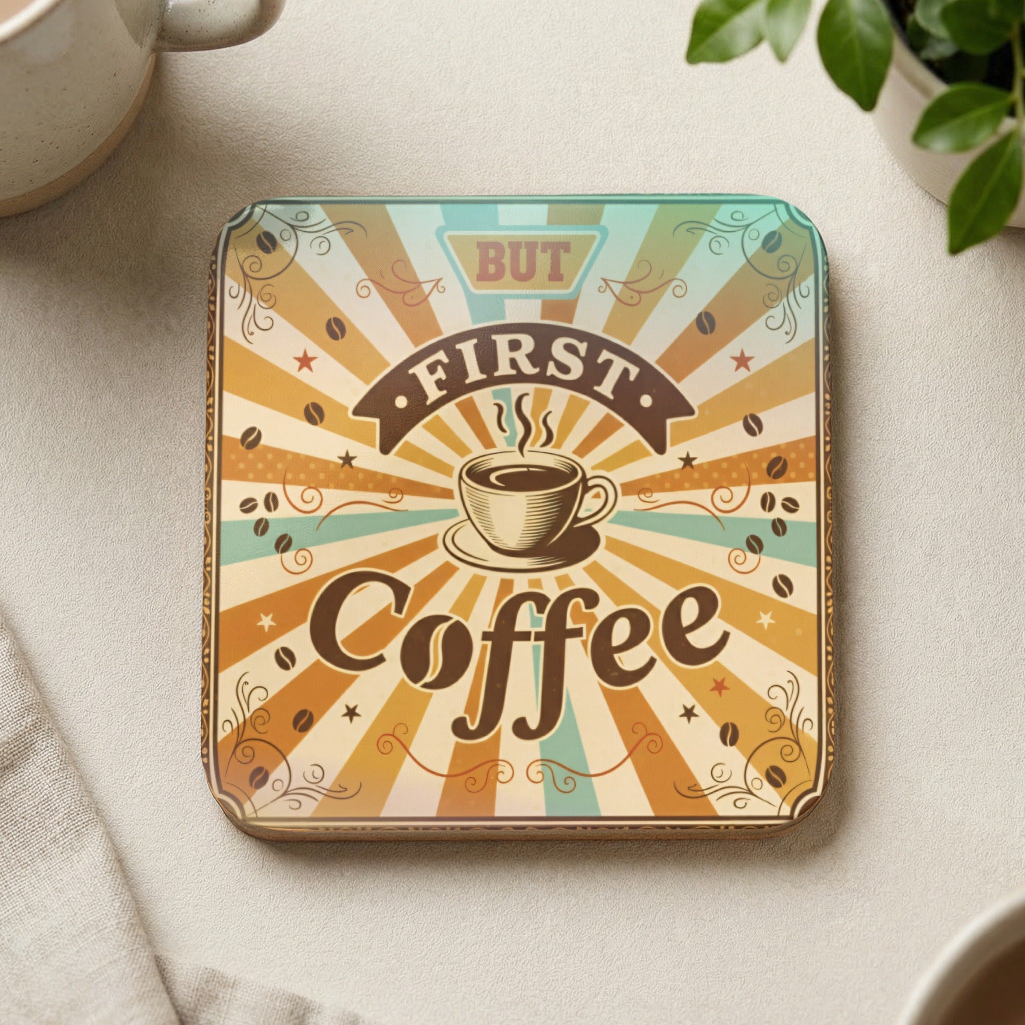 Square coaster with "But First Coffee" text and sunburst design.