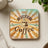 Square coaster with "But First Coffee" text and sunburst design.
