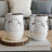 Two wine tumblers with heart-shaped wine splash design on white background.