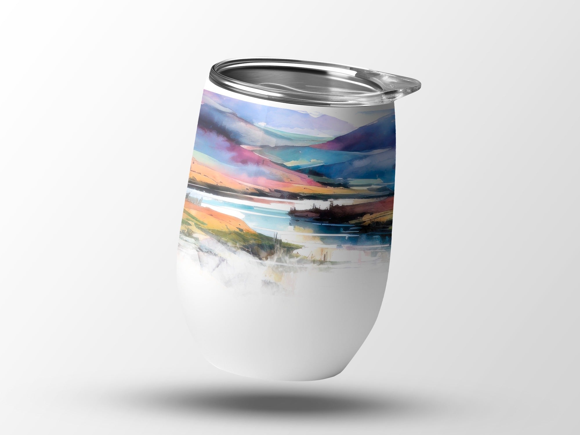 White tumbler with a colorful landscape watercolor design.