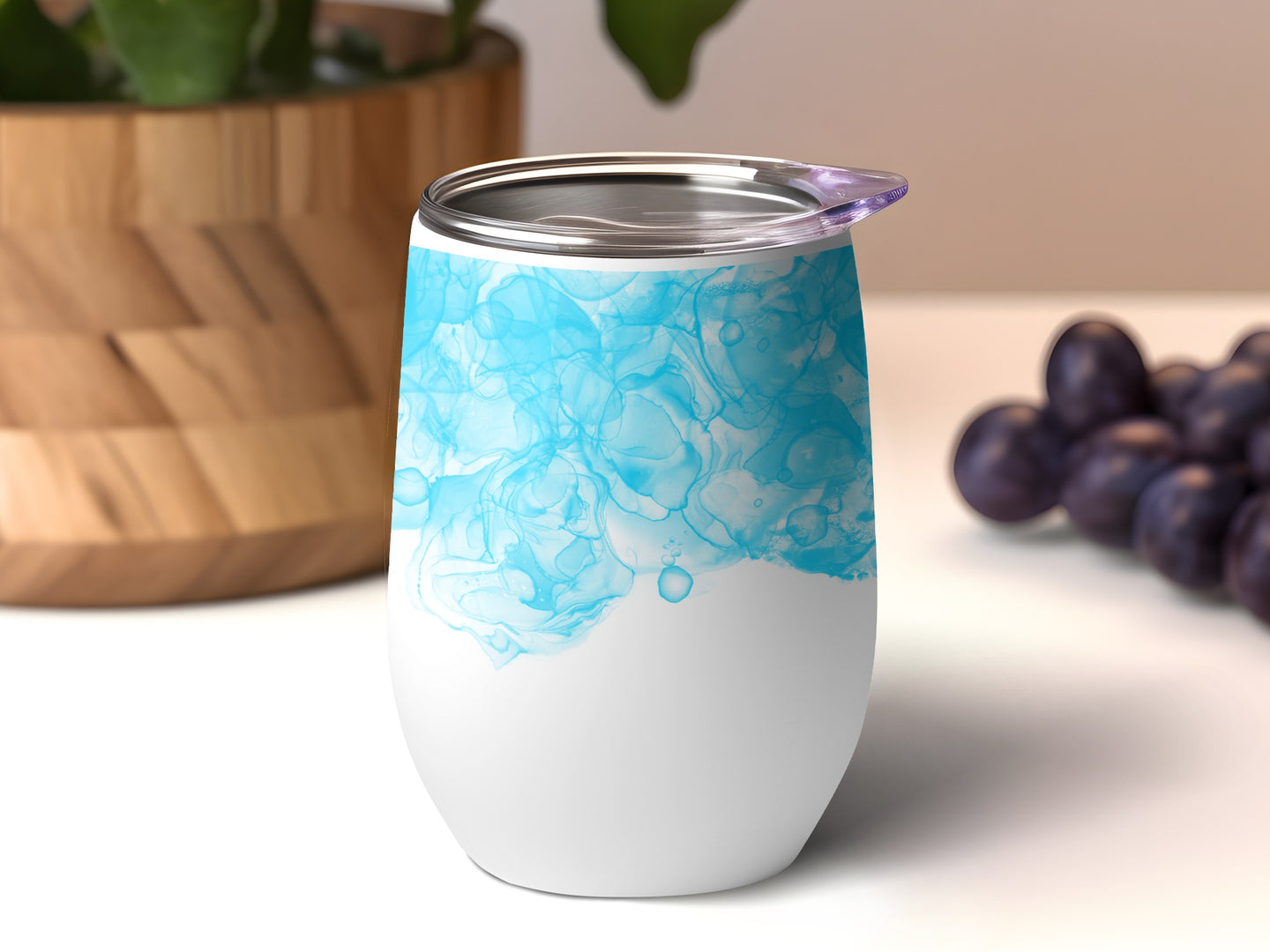 White tumbler with blue watercolor abstract design.