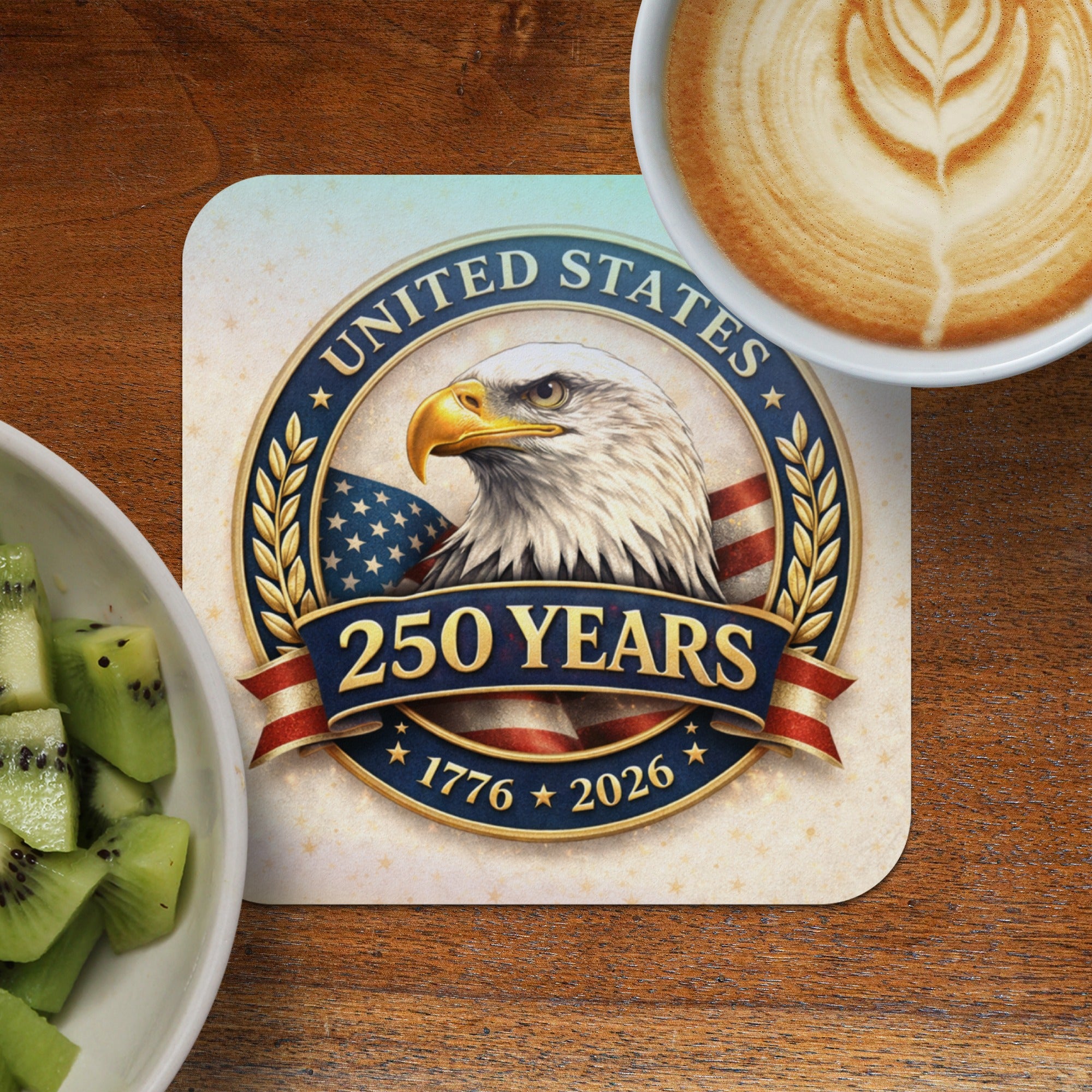 United States 250 Years 1776-2026 emblem with eagle and flag, next to kiwi and coffee.