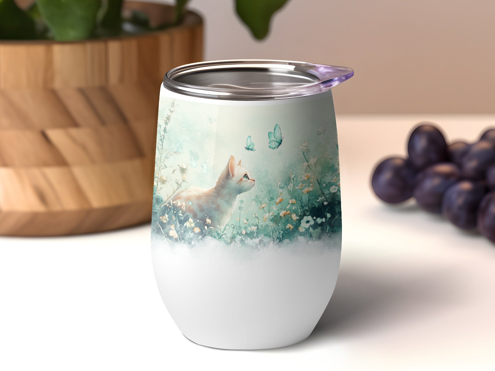 White tumbler with a kitten, butterflies, and floral design.