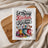 White waffle weave kitchen towel with "A Messy Kitchen is a Happy Kitchen" text and kitchen utensils.