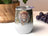 Boho lion with feathers and gold accents on a white insulated tumbler.