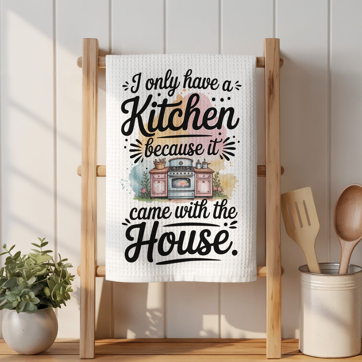 Towel with "I only have a Kitchen because the House." text.