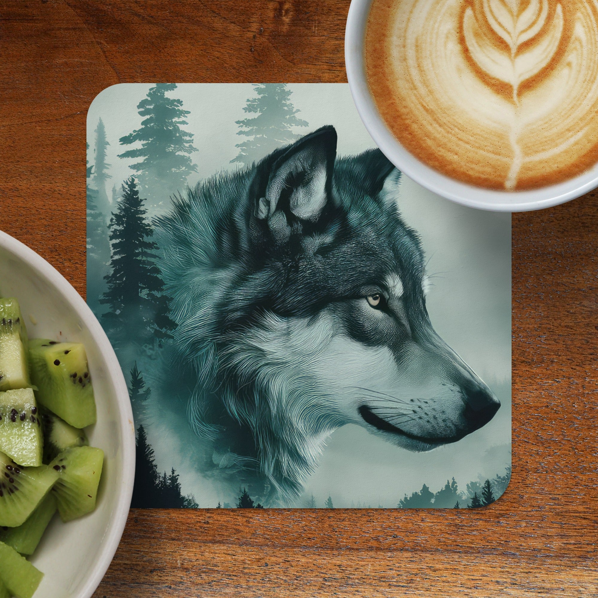Wolf portrait on coaster next to coffee and kiwi slices.