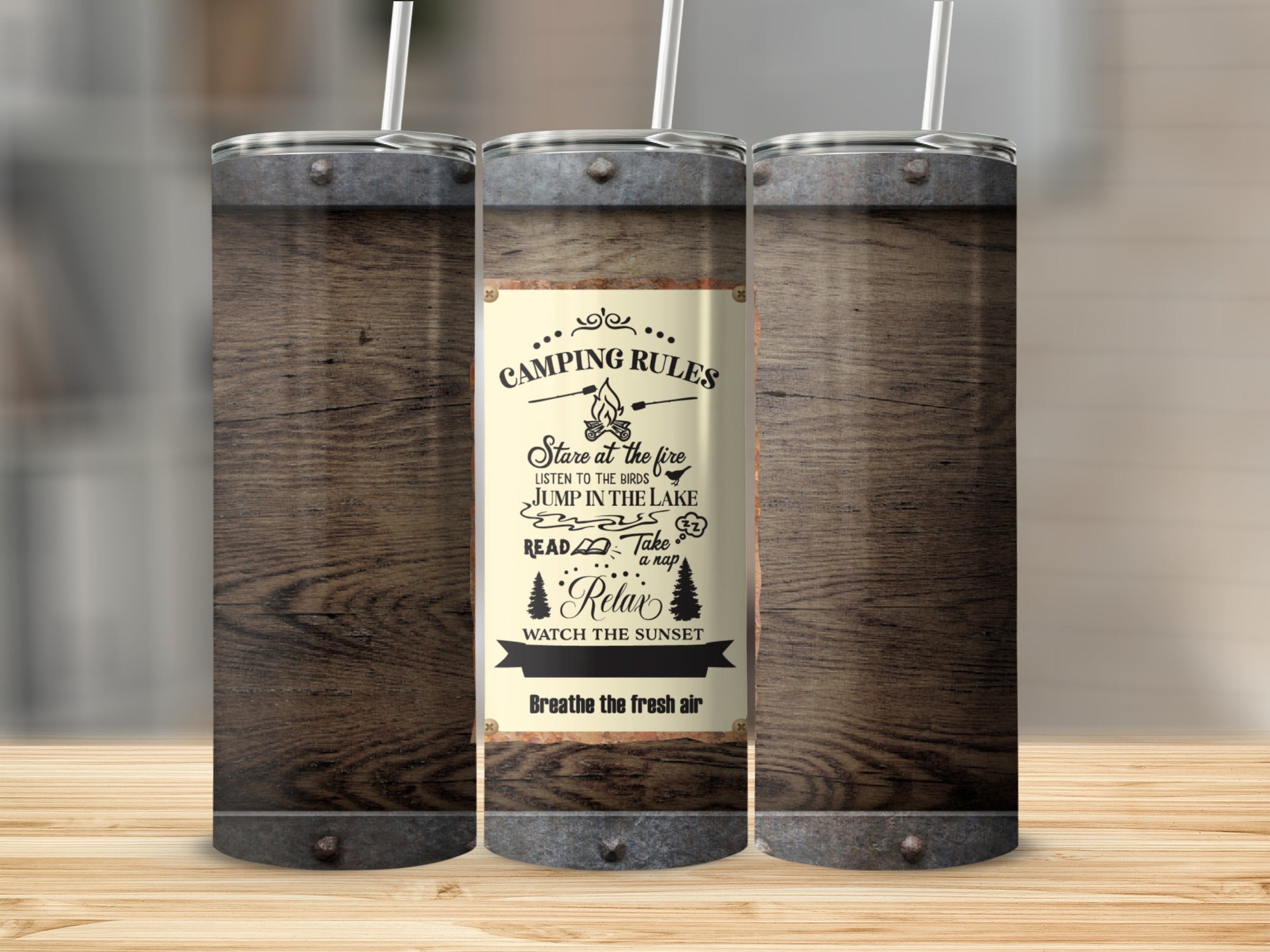 Tumbler with "Camping Rules" text including staring at fire, listening to birds, and relaxing.